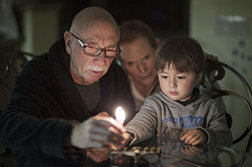 A grandfather lighting something with his grandson. Links to Beneficiary Designations
