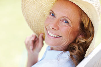 A woman wearing a straw hat. Links to Gifts of Cash, Checks, and Credit Cards